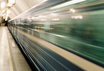 Fototapeta na wymiar Subway train leaving its station - motion blur while passing a train. film photography