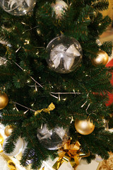 Christmas decorations on the Christmas tree. Transparent balls with a bow inside.