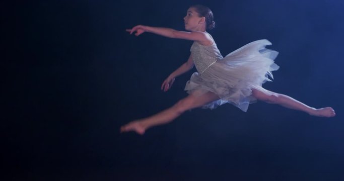 Ballerina leaping in super slow motion, young girl