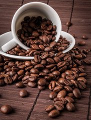 Coffee cup and a scattering of coffee beans