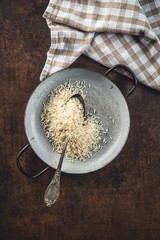 Uncooked indian long rice in pan.