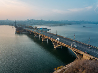 Fototapeta premium Aerial autumn Voronezh cityscape from drone flight height. View of the Vogresovsky bridge over Voronezh Water Reservoir