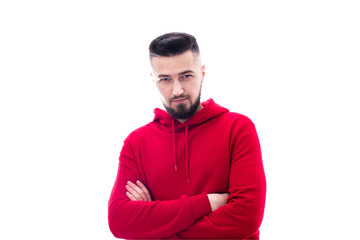 Handsome man in red casual clothes posing with arms crossed on white background