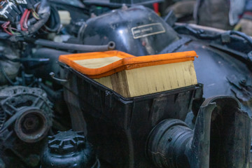 close-up of old orange air filter on car, repair concept