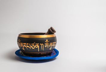 Tibetan handcrafted singing bowl with stick isolated on white background