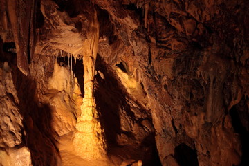 Caving and exploring amazing underground caves with beautiful geological rock formations of speleothems, stalactites and stalagmites