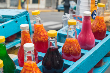 Bottles - Flavored Ice Carriage in Santiago, Dominican Republic. - obrazy, fototapety, plakaty