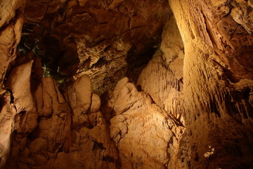 Caving and exploring amazing underground caves with beautiful geological rock formations of speleothems, stalactites and stalagmites