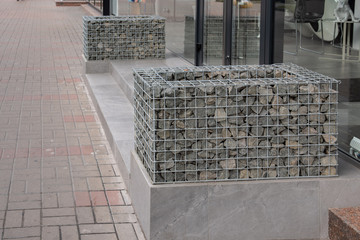 Porch of the shop decorated with stones in an iron mesh