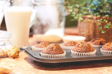 Freshly baked homemade muffins in a muffin pan on the kitchen table.