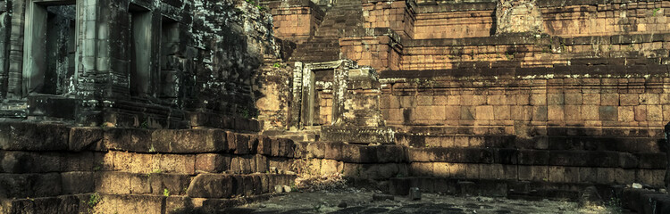 detailed carvings pink limestone walls of Banteay Srei temple Cambodia