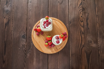 Homemade yogurt in a jar close-up. Fermented milk product with strawberries and copy space.