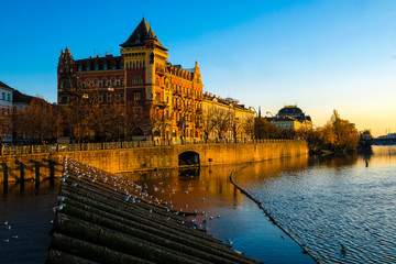 Fototapeta premium image of the embankment of the Vltava river in Prague at sunset
