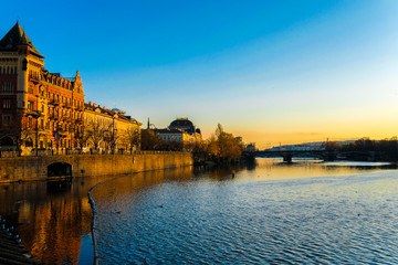 image of the embankment of the Vltava river in Prague at sunset