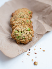 Homemade oatmeal cookies with rhubarb as a toping on a piece of craft paper.