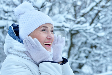 Portrait of happy beautiful senior woman in warm hat