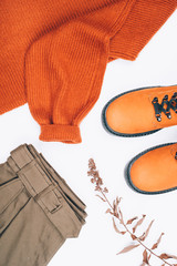 Warm clothes and boots on the table. Spring-Summer 2020 Colors. Flat lay.