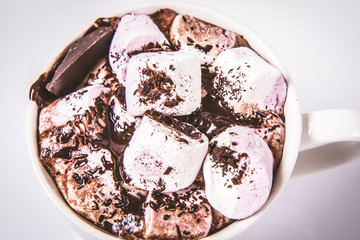 Cup of hot chocolate with marshmallows on a white background
