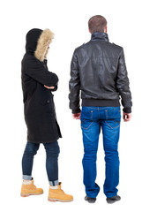 Back view of couple in winter jacket.