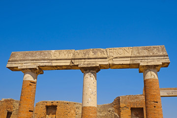 Ancient city Pompeii with arches, forum, columns, houses and streets. Ruins of Roman city destroyed by the eruption of volcano, Mount Vesuvius. Naples, Italy. Popular Italian travel destination.