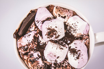 Cup of hot chocolate with marshmallows on a white background