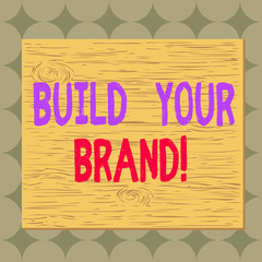 Conceptual hand writing showing Build Your Brand. Concept meaning creates or improves customers knowledge and opinions of product Square rectangle unreal cartoon wood on the coloured wall