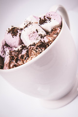 Cup of hot chocolate with marshmallows on a white background