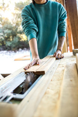 A woman works in a carpentry workshop.