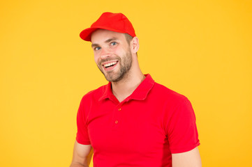 friendly shop assistant. food order deliveryman. cashier vacancy. Hiring shop store worker. happy guy. dealer yellow wall. Salesman cashier career. man delivery service in red tshirt and cap