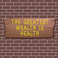 Text sign showing The Greatest Wealth Is Health. Business photo showcasing Many sacrifice their money just to be healthy Plank wooden board blank rectangle shaped wood attached color background