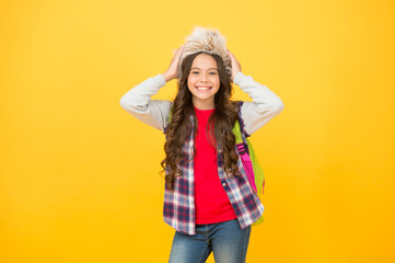 Winter events at school. Winter entertainment and activities. Child schoolgirl soft hat enjoy season. Kid girl wear hat with ear flaps. Winter vacation. Submit learning goals reflections for semester