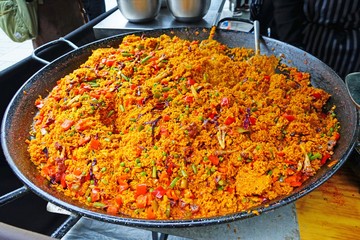 Giant vegetarian rice paella dish in a traditional pan