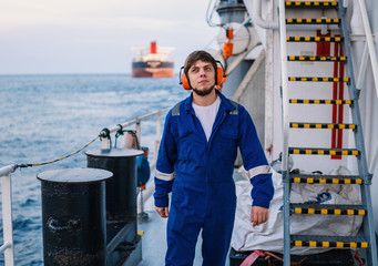 Engineer or officer on deck of offshore vessel or ship , wearing PPE personal protective equipment...