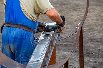 Worker grinding piece of metal