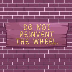 Text sign showing Do Not Reinvent The Wheel. Business photo showcasing stop duplicating a basic method previously done Plank wooden board blank rectangle shaped wood attached color background