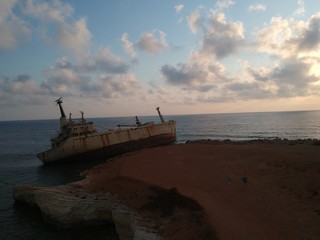 Fototapeta na wymiar Edro III - Ship after a shipwreck, coast with cliffs at sunset, Cyprus, Mediterranean Sea