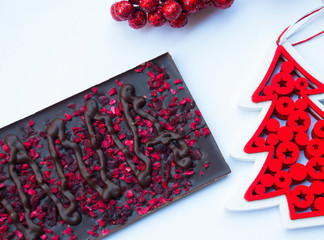 Homemade chocolate with pink dry berries.