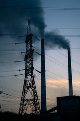 high voltage post. High-voltage tower sky background, factory pipe with smoke over it. Earth...