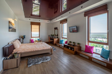 Bedroom in modern apartment. White walls. King-size bed. Light interior.