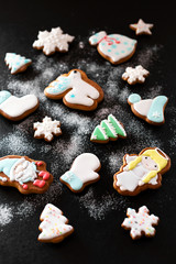 Christmas gift gingerbread on dark background.  Christmas gingerbread cookies with icing sugar. Top view