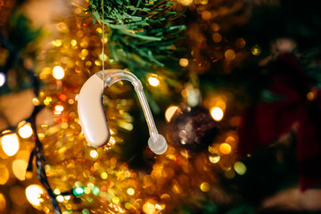 Hearing aid on festive background.