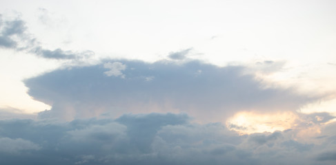 Massive thundercloud against a light sky, chase small dark clouds in front of you