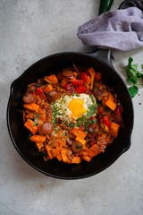 Skillet baked sweet potato breakfast Hash with fried egg, top view