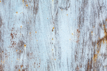 texture of an old rusty sheet of metal painted with white paint burnt out in the sun