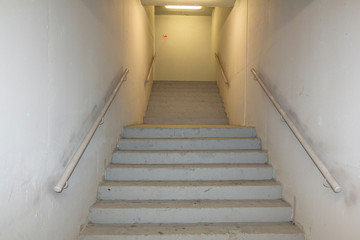 Industrial construction staircase with lights, white plaster