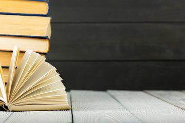 Open book, hardback books on wooden table. Back to school. Copy space