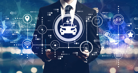 EV concept with businessman holding a tablet computer