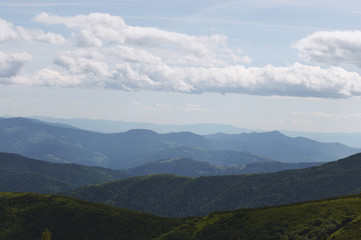 Beautiful mountain landscape, with mountain peaks covered with forest and cloudy sky.Ukrainian Carpathian Mountains