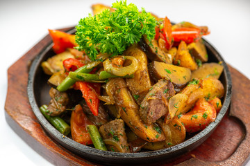 These are baked potatoes with vegetables and slices of juicy meat