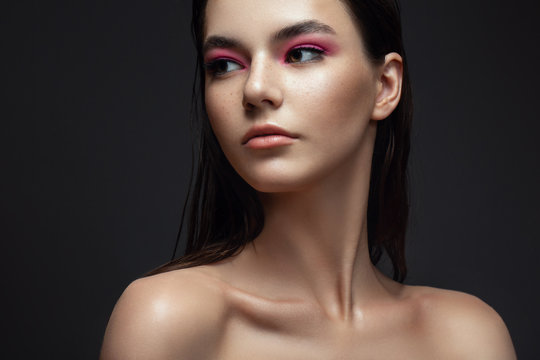 Beautiful model girl with elegant haircut. Woman with pink make-up. Cosmetics, beauty.